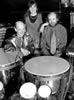 Black & white photo of performers with a variety of their instruments