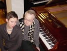 Both artists sitting at a piano