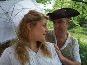 Two key players from White Horse Opera in a garden looking at each other