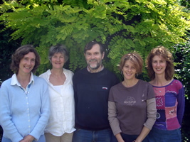 Pentatonic standing in front of a conifer hedge