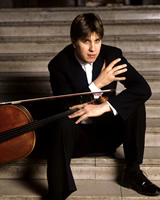 Thomas Carroll sitting on stone steps with cello