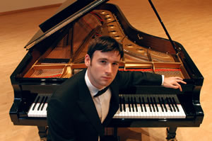 John Paul Ekins sitting at a piano