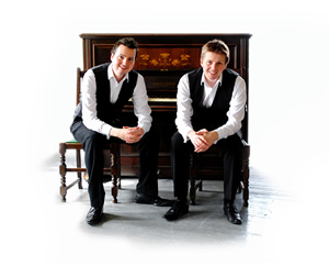 The Scott Brothers sitting at a piano