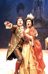 Two performers from Swansea City Opera performing on stage in costume