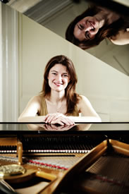 Emma Abbate seated at a piano