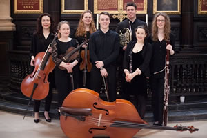 The Temple Ensembe standing with their instruments