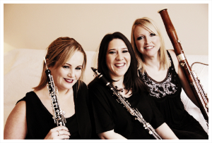 The Thorne Trio seated with their instruments