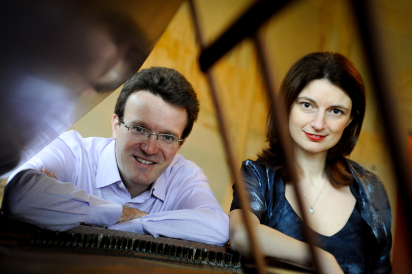 Photo of Emma Abbate and Julian Perkins looking through top of grand piano