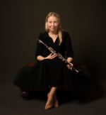 Katherine Spencer sitting and holding her clarinet.